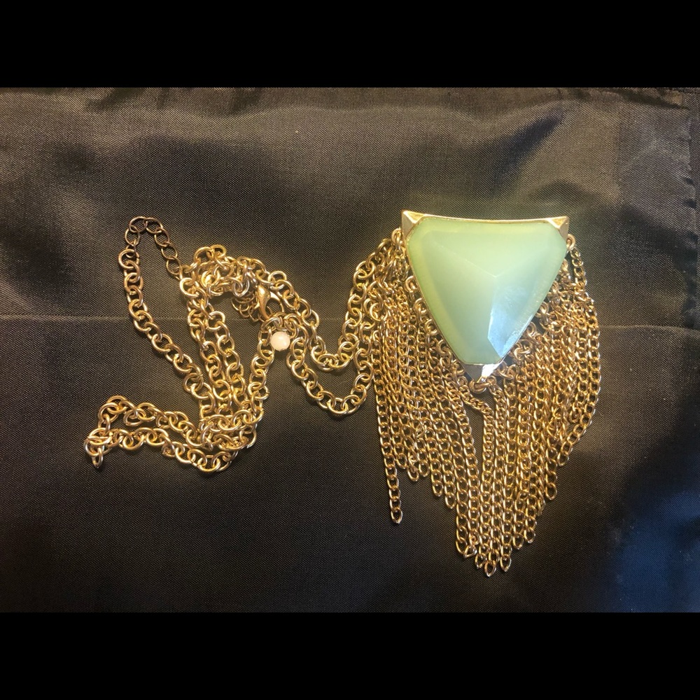 Vintage triangle shaped light green crystal like stone.